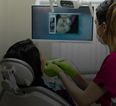 Dentist and patient looking at intraoral images on computer monitor